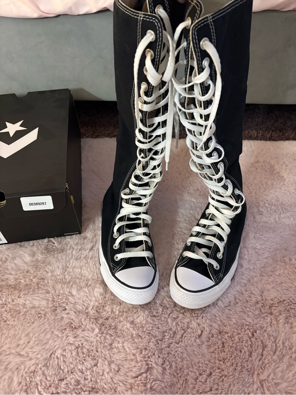 Black Converse knee high sneakers with white laces